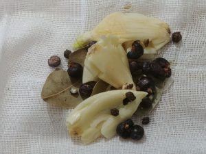 garlic, juniper berries, peppercorns and bay leaves in cheesecloth